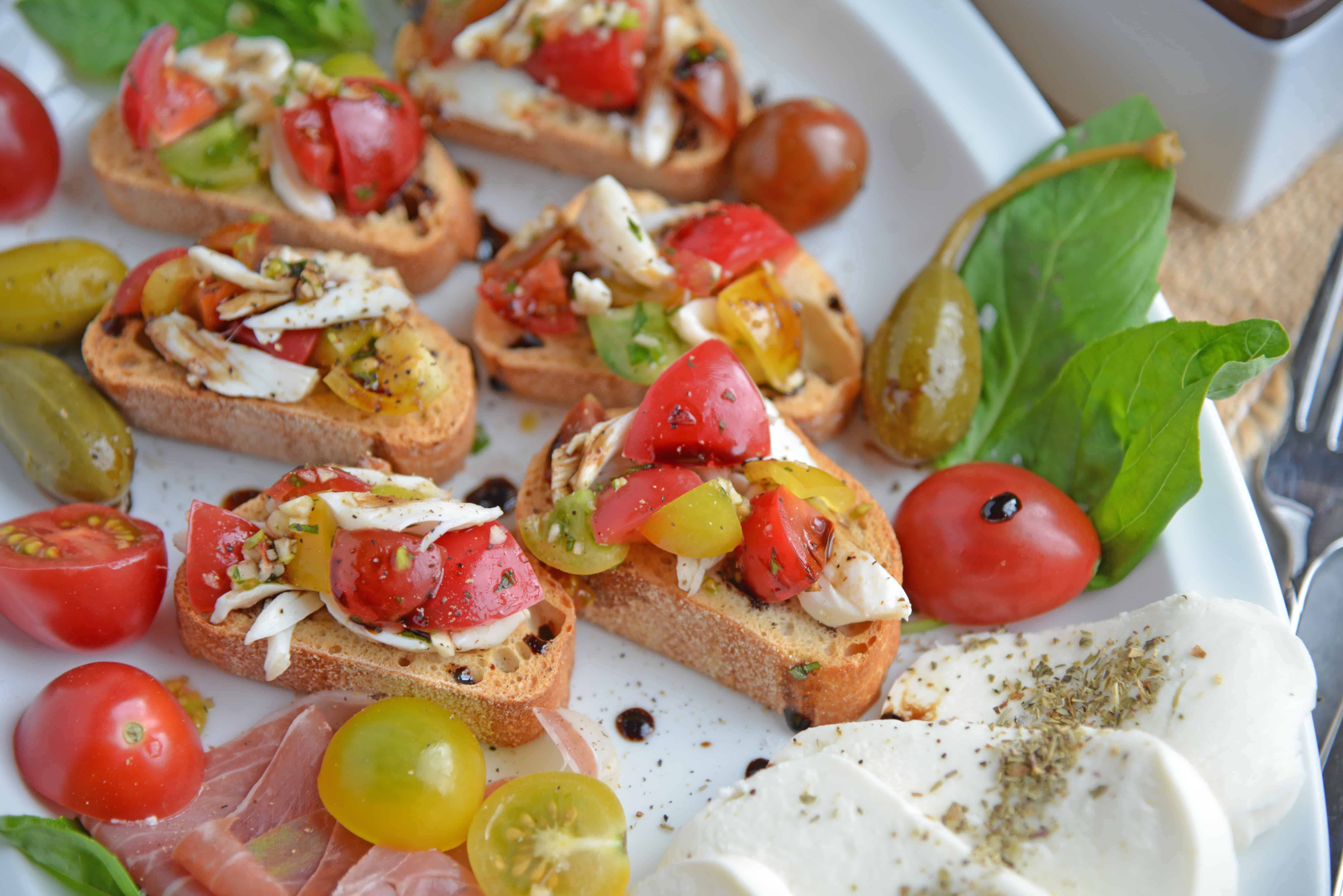 Crab Bruschetta is a mound of fresh tomatoes, garlic basil and buttery crab meat piled high on crispy toast. This is one of the best appetizers out there! #crabbruschetta #easybruschetta www.savoryexperiments.com