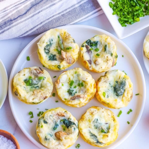 overhead of egg muffins on a white plate