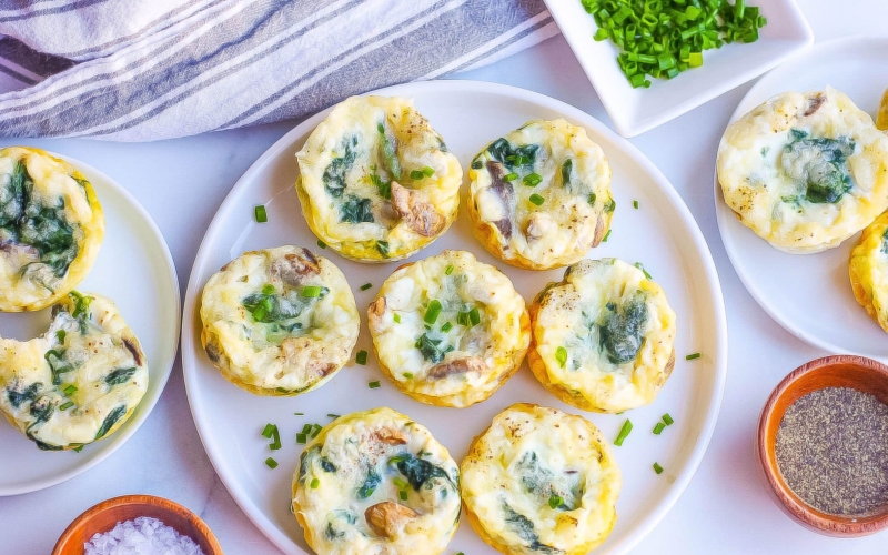 overhead of egg muffins on a white plate