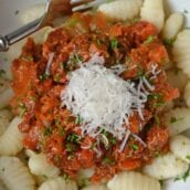 Slow Cooker Ragu uses a blend of 7 vegetables with shredded pork and flavorful spices to make a hearty and delicious ragu sauce. Serve over pasta. Also freezer friendly! #slowcookerragu #slowcookerrecipes www.savoryexperiments.com