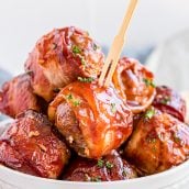 bowl of bacon wrapped meatballs with a wooden toothpick