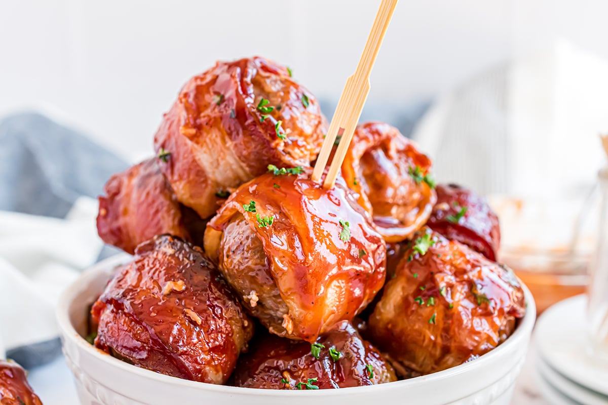 bowl of bacon wrapped meatballs with a wooden toothpick