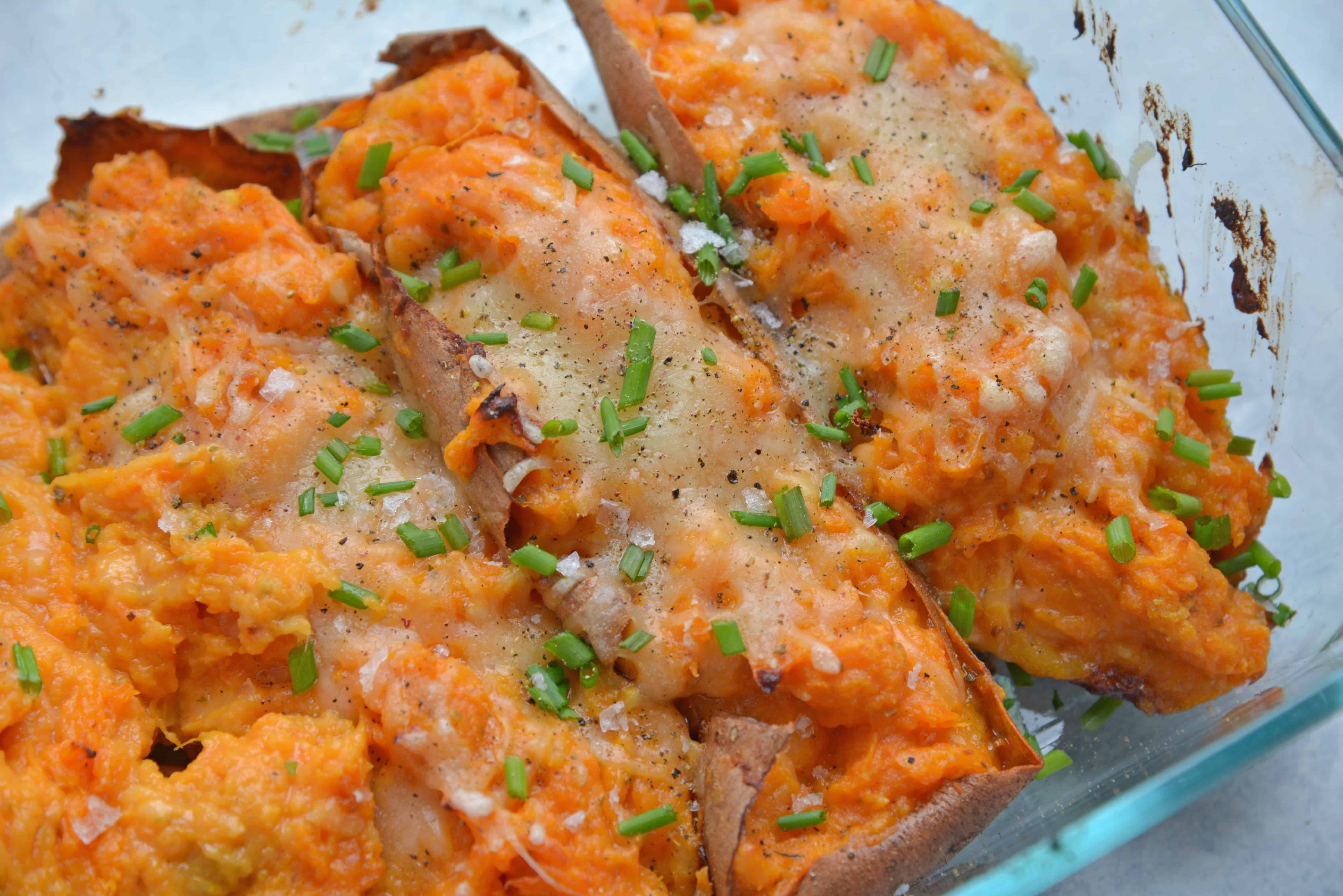 angle view of stuffed sweet potato with cheese and chives 