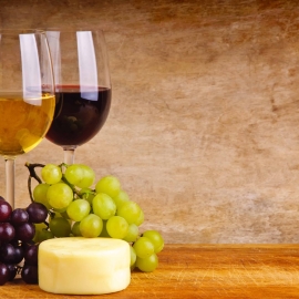 A glass of wine sitting on top of a wooden table