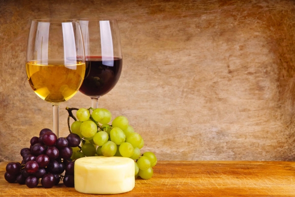 A glass of wine sitting on top of a wooden table