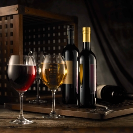 A bottle of wine glasses sitting on a table