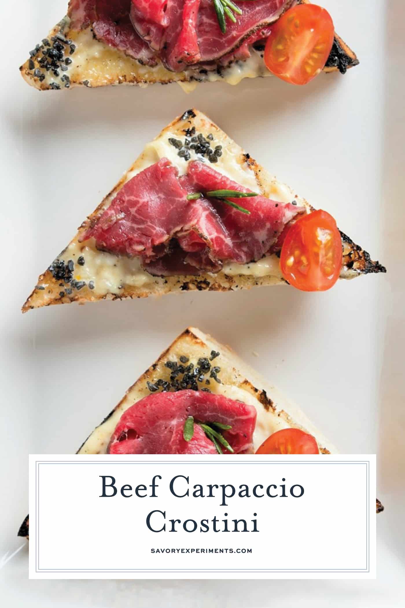 Beef Carpaccio Crostini are thinly sliced pieces of beef with garlic aioli, black sea salt and fresh rosemary with tomato. The perfect party appetizer. #beefcarpaccio #crostinirecipes www.savoryexperiments.com