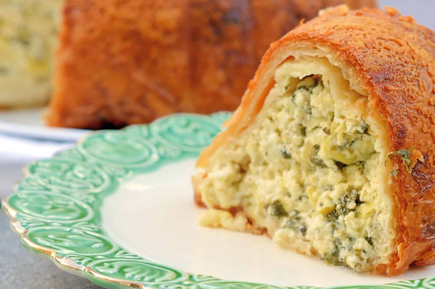 This Cheese Torte combines 3 types of cheese with spinach, artichoke and seasoning in crispy layers of buttery Phyllo dough. The ultimate appetizer, side dish or brunch dish! #cheesetorte #spinachandartichoke www.savoryexperiments.com