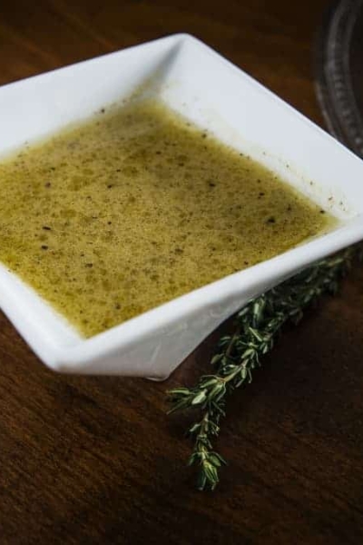 Dijon Lime Salad Dressing in a white bowl with a spoon next to it