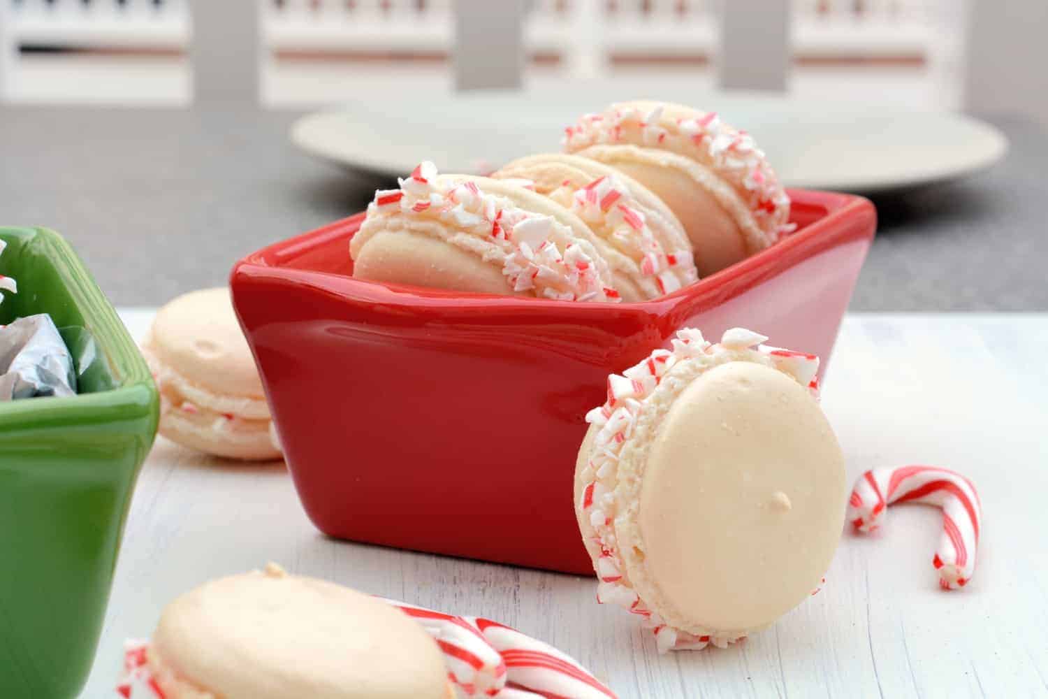 Peppermint Twist Macarons are an easy macaron recipe with a buttercream filling. Perfect recette macarons for Christmas cookies and holiday parties. #easymacaronrecipe #christmascookies www.savoryexperiments.com 