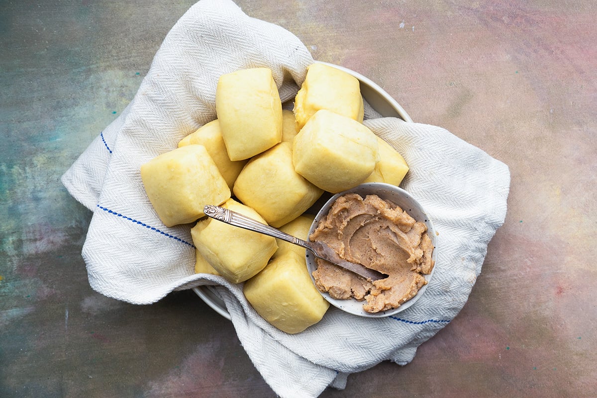 basket of yeast rolls with honey cinnamon butter