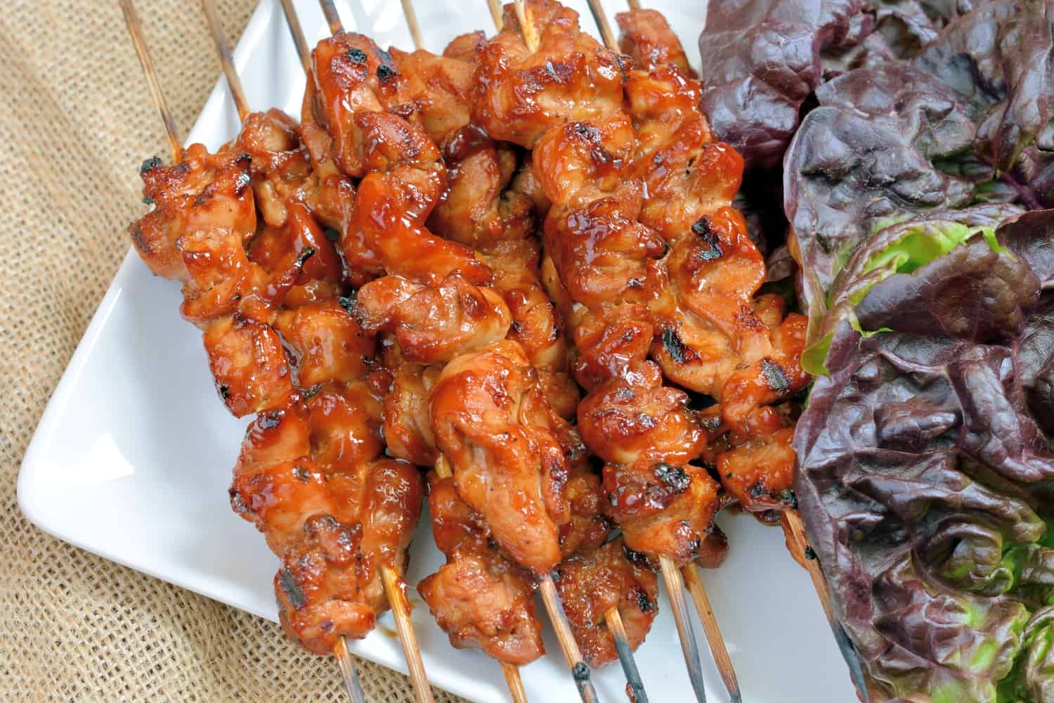 BBQ Chicken Lettuce Wraps use seasoned chicken with your favorite BBQ sauce and wrap them in crispy lettuce with juicy tomatoes, blue cheese and cool avocado dressing. #lettucewraps www.savoryexperiments.com 