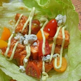 BBQ Chicken Lettuce Wraps use seasoned chicken with your favorite BBQ sauce and wrap them in crispy lettuce with juicy tomatoes, blue cheese and cool avocado dressing. #lettucewraps www.savoryexperiments.com