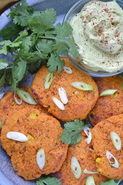 sweet potato pancakes with scallions on a blue plate