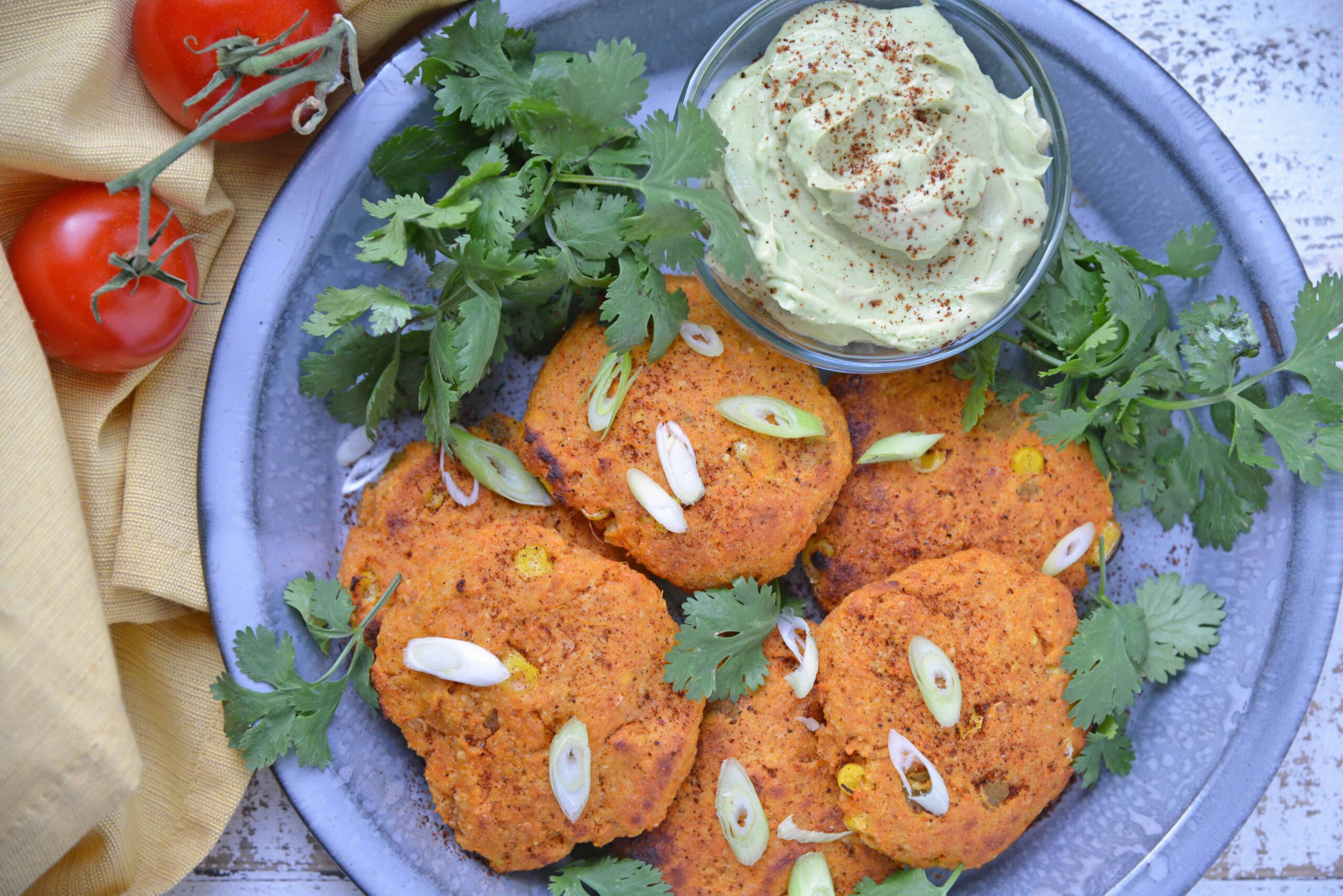 sweet potato pancakes with scallions on a blue plate