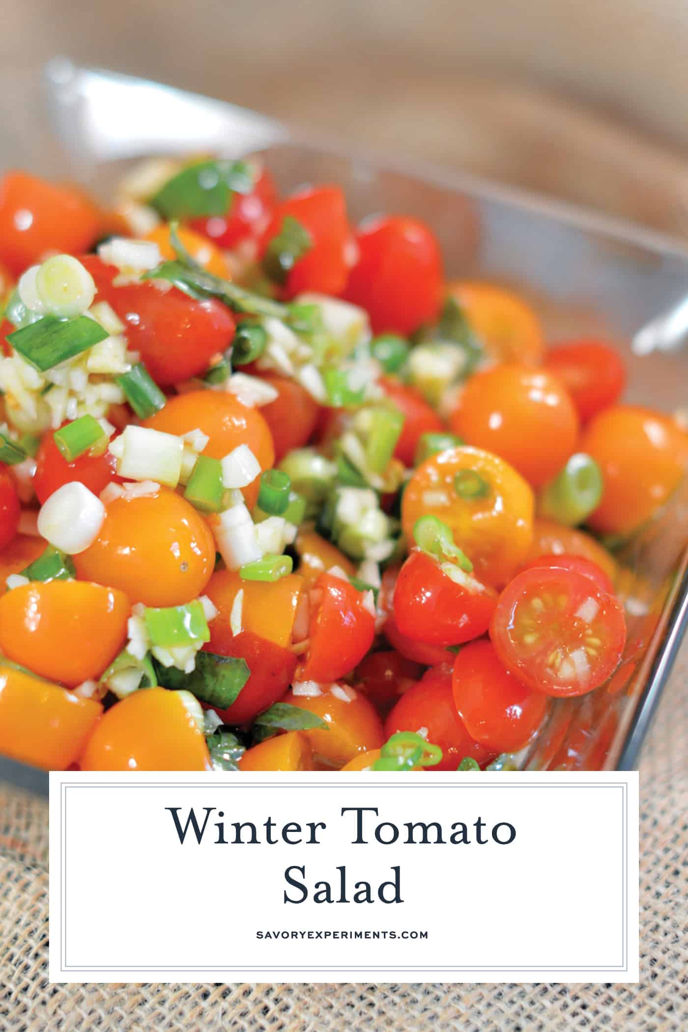 Winter Tomato Salad uses multi-colored cherry tomatoes, lots of garlic, good olive oil and basil to make a tasty side dish recipe perfect for the winter months. #tomatosalad #tomatosidedishes www.savoryexperiments.com