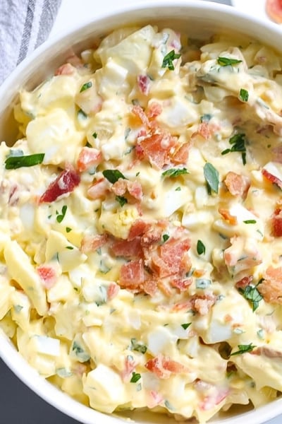 close up of egg salad with bacon in a serving bowl