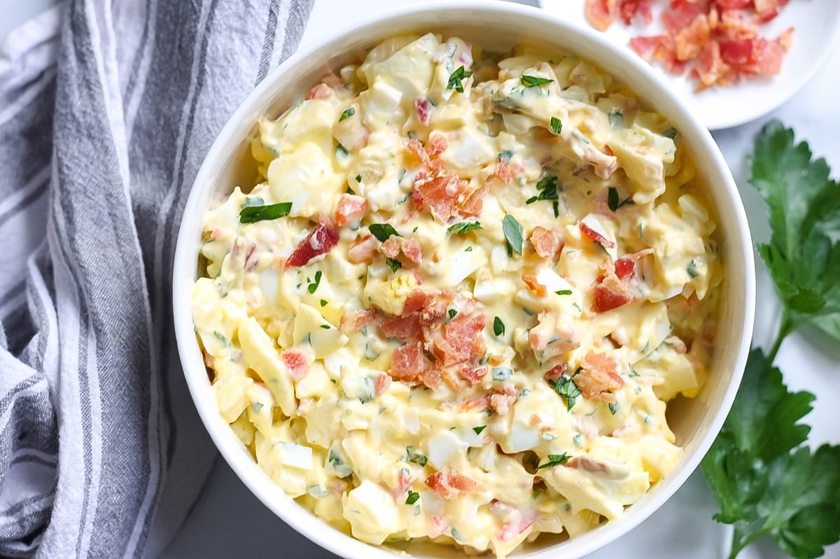 close up of egg salad with bacon in a serving bowl