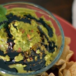 Guacamole with balsamic reduction is a great, new twist on an old favorite. Perfect for every party or just an afternoon snack. #guacamole #balsamicreduction #chipdip www.savoryexperiments.com