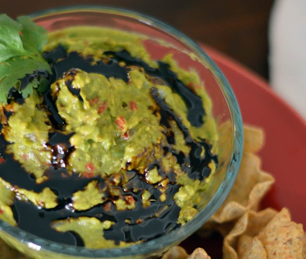 Guacamole with balsamic reduction is a great, new twist on an old favorite. Perfect for every party or just an afternoon snack. #guacamole #balsamicreduction #chipdip www.savoryexperiments.com