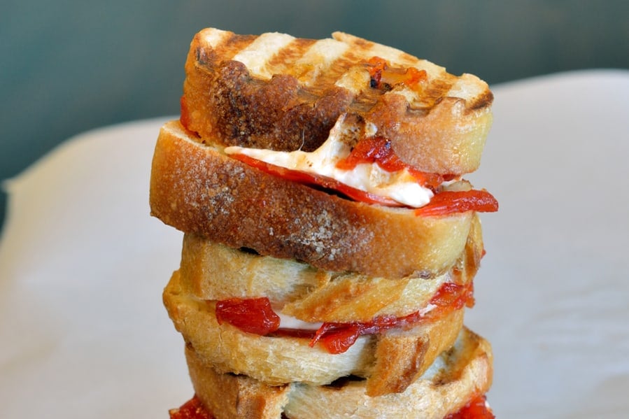 Cheesy Pizza Sandwiches are mini, slider-size grilled cheese sandwiches with mozzarella cheese, tomato jam and pepperoni. Kid friendly and great for parties! #pizzasandwiches www.savoryexperiments.com