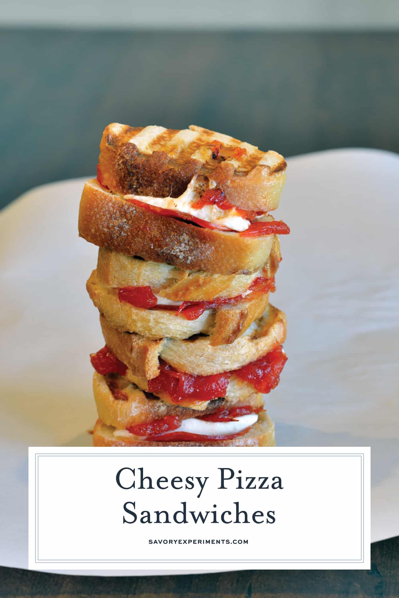 Cheesy Pizza Sandwiches are mini, slider-size grilled cheese sandwiches with mozzarella cheese, tomato jam and pepperoni. Kid friendly and great for parties! #pizzasandwiches www.savoryexperiments.com