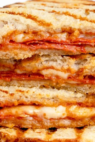 close up of a pizza sandwich cut and piled