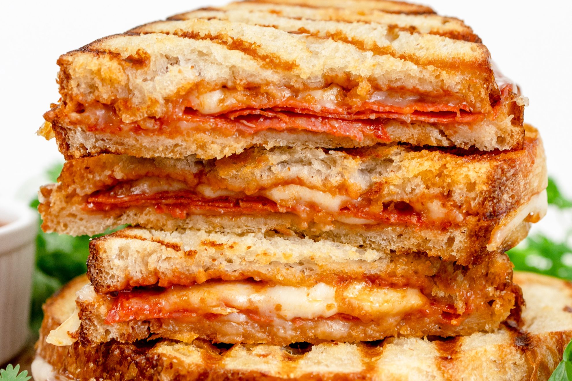 close up of a pizza sandwich cut and piled