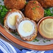 Scotch Eggs on a platter, one cut in half