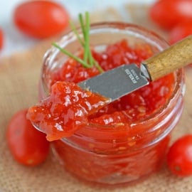 Tangy and sweet, tomato jam is excellent on everything from grilled cheese to deviled eggs, hamburgers and charcuterie boards. #tomatojam #homemadejamrecipe www.savoryexperiments.com