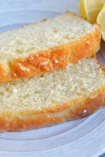 Yogurt, fresh lemon and almond give this sunny loaf cake a unique flavor and texture that everyone will love. Perfect for brunch, tea or dessert! #loafcake #lemoncake #almondcake www.savoryexperiments.com