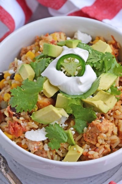 Southwest Chicken Casserole is an easy one-dish meal using chicken, rice, black beans, tomato, corn and southwest spices. #chickencasserole #onedishchickenrecipe www.savoryexperiments.com