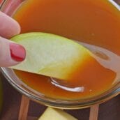 A bowl of fruit, with Caramel and Sauce