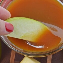 A bowl of fruit, with Caramel and Sauce