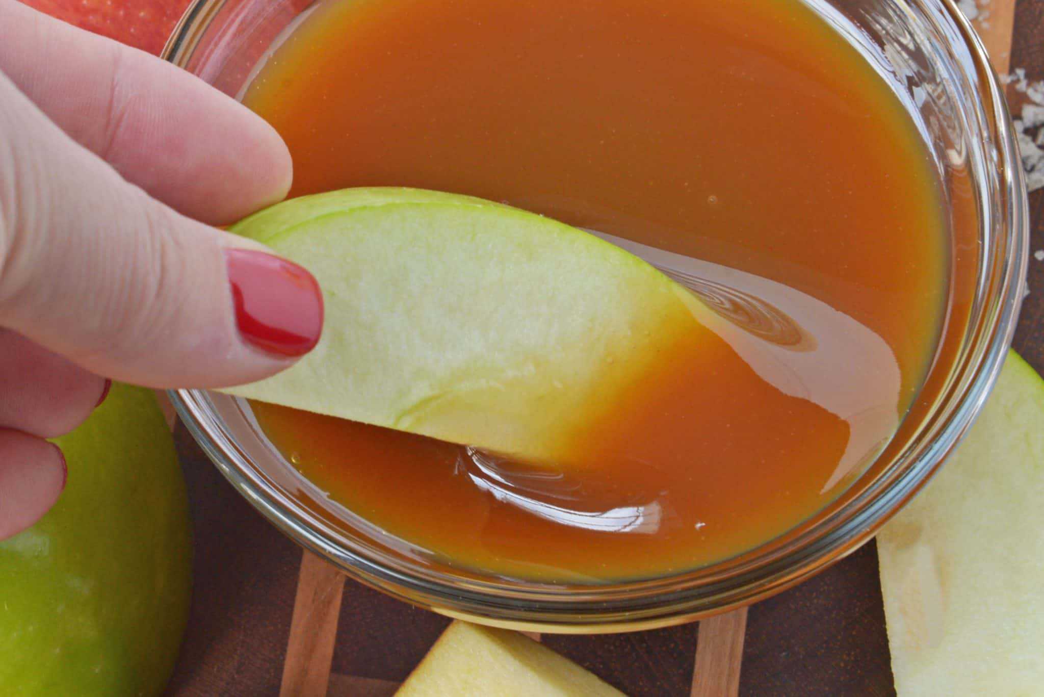 A bowl of fruit, with Caramel and Sauce