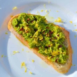 Serve Lemony Pea Mash Crostinis with at room temperature with a chilled, crisp white wine for a vibrant and colorful appetizer. | #peacrostinis | www.savoryexperiments.com