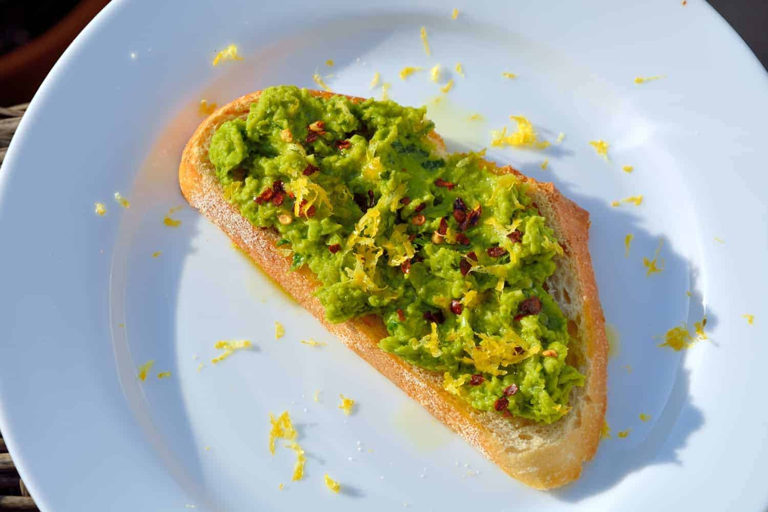 Serve Lemony Pea Mash Crostinis with at room temperature with a chilled, crisp white wine for a vibrant and colorful appetizer. | #peacrostinis | www.savoryexperiments.com