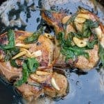 Butter Sage Pork Chop Recipe- Crispy sage and garlic top succulent thick cut bone-in pork chops prepared in cast iron. | #castironcooking | www.savoryexperiments.com