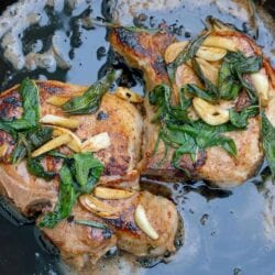 Butter Sage Pork Chop Recipe- Crispy sage and garlic top succulent thick cut bone-in pork chops prepared in cast iron. | #castironcooking | www.savoryexperiments.com