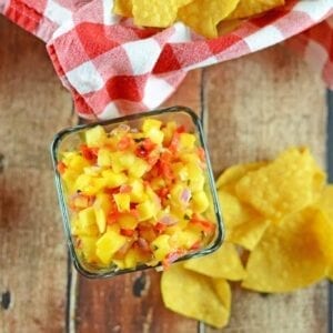 Fresh Mango Salsa is a fruity salsa recipe perfect for serving with tortilla chips or even on top of grilled chicken, steak or seafood. Perfect for BBQs and potlucks. #mangosalsa #fruitsalsarecipes www.savoryexperiments.com