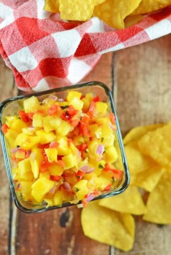 Fresh Mango Salsa is a fruity salsa recipe perfect for serving with tortilla chips or even on top of grilled chicken, steak or seafood. Perfect for BBQs and potlucks. #mangosalsa #fruitsalsarecipes www.savoryexperiments.com