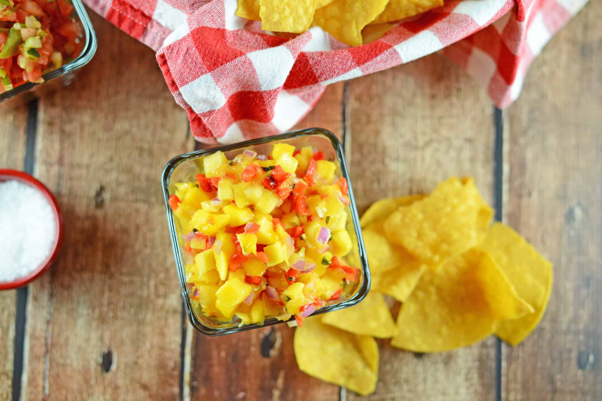 Fresh Mango Salsa is a fruity salsa recipe perfect for serving with tortilla chips or even on top of grilled chicken, steak or seafood. Perfect for BBQs and potlucks. #mangosalsa #fruitsalsarecipes www.savoryexperiments.com