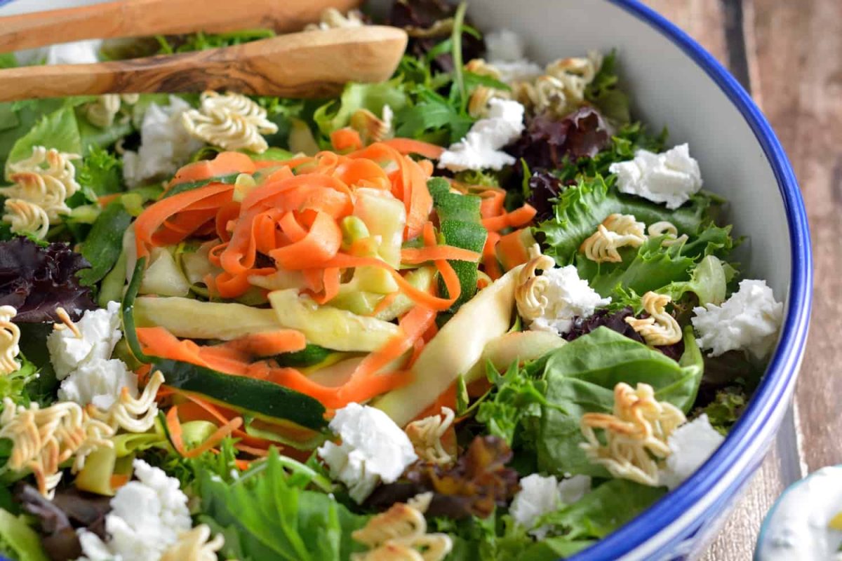 Shaved Zucchini Salad with Lemon-Chive Dressing - spring greens, soft goat cheese, toasted ramen croutons, marinated zucchini, squash and carrots with a yogurt-based lemon chive dressing. #zucchinisalad #homemadesaladdressing www.savoryexperiments.com