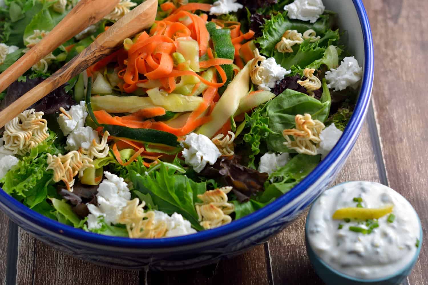 Shaved Zucchini Salad with Lemon-Chive Dressing - spring greens, soft goat cheese, toasted ramen croutons, marinated zucchini, squash and carrots with a yogurt-based lemon chive dressing. #zucchinisalad #homemadesaladdressing www.savoryexperiments.com