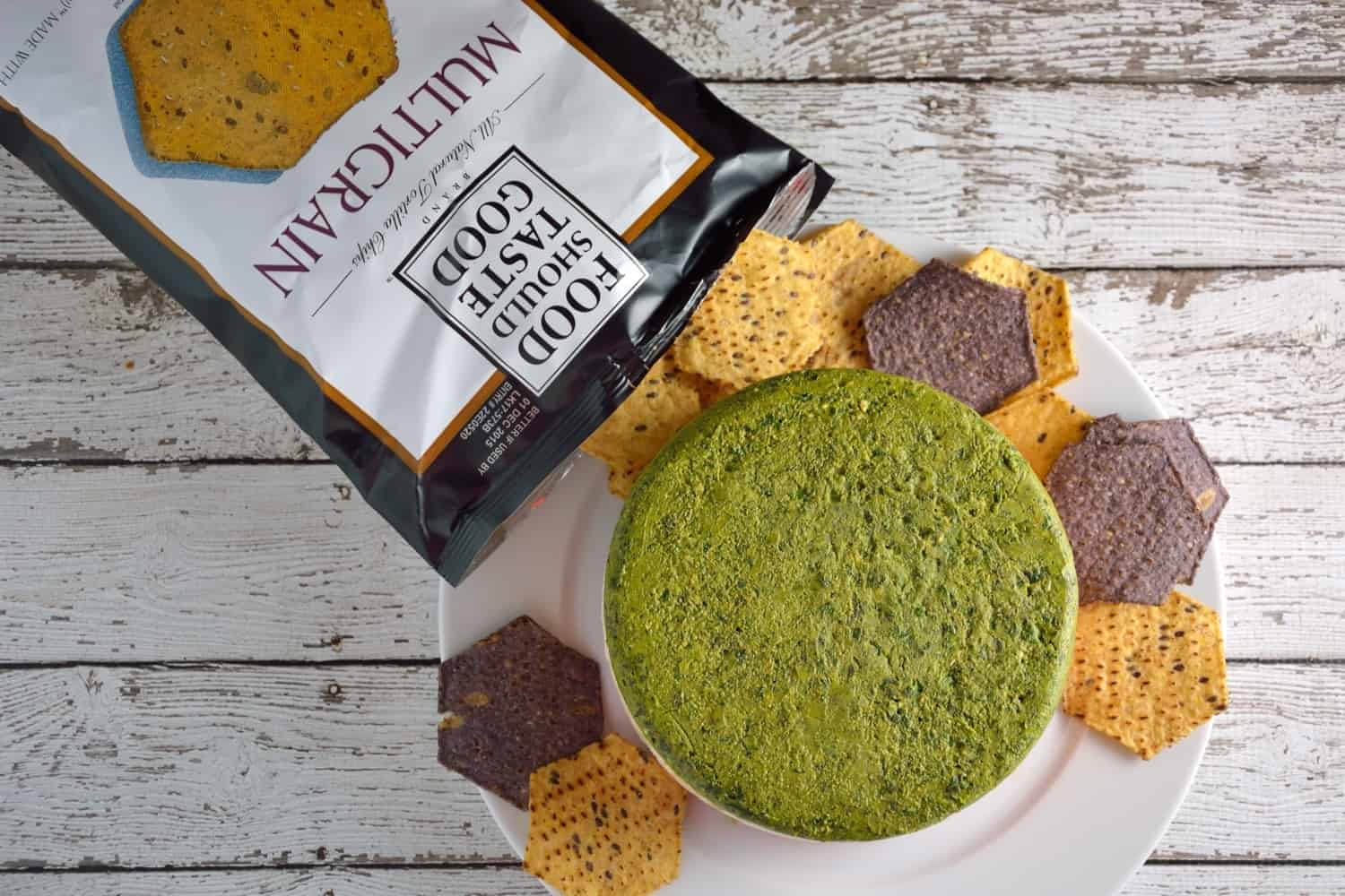 Layered Two Pesto and Ricotta Dip recipe features three distinct layers of red and green pesto with blended cheeses paired with Food Should Taste Good™ chips. | #foodshouldtastegood #sp | www.savoryexperiments.com