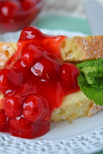 Slice of almond pound cake topped with cherries