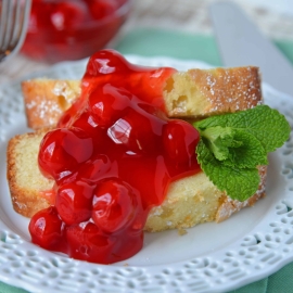 Slice of almond pound cake topped with cherries