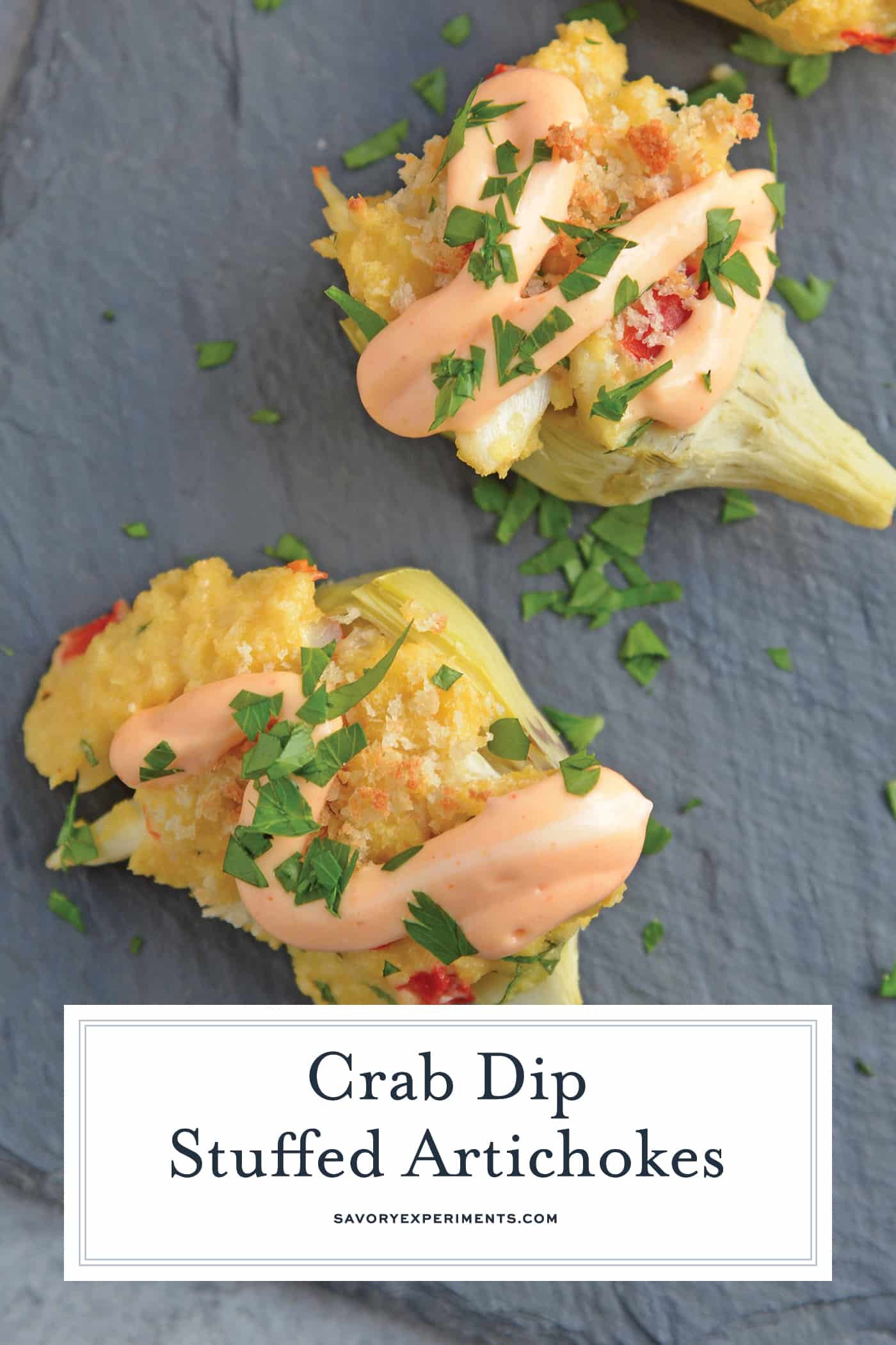 Crab Dip Stuffed Artichoke Hearts takes traditional hot crab dip and bakes in an artichoke heart, topping it with crunchy panko and Sriracha Aioli. #hotcrabdip #artichokerecipes #crabappetizers www.savoryexperiments.com