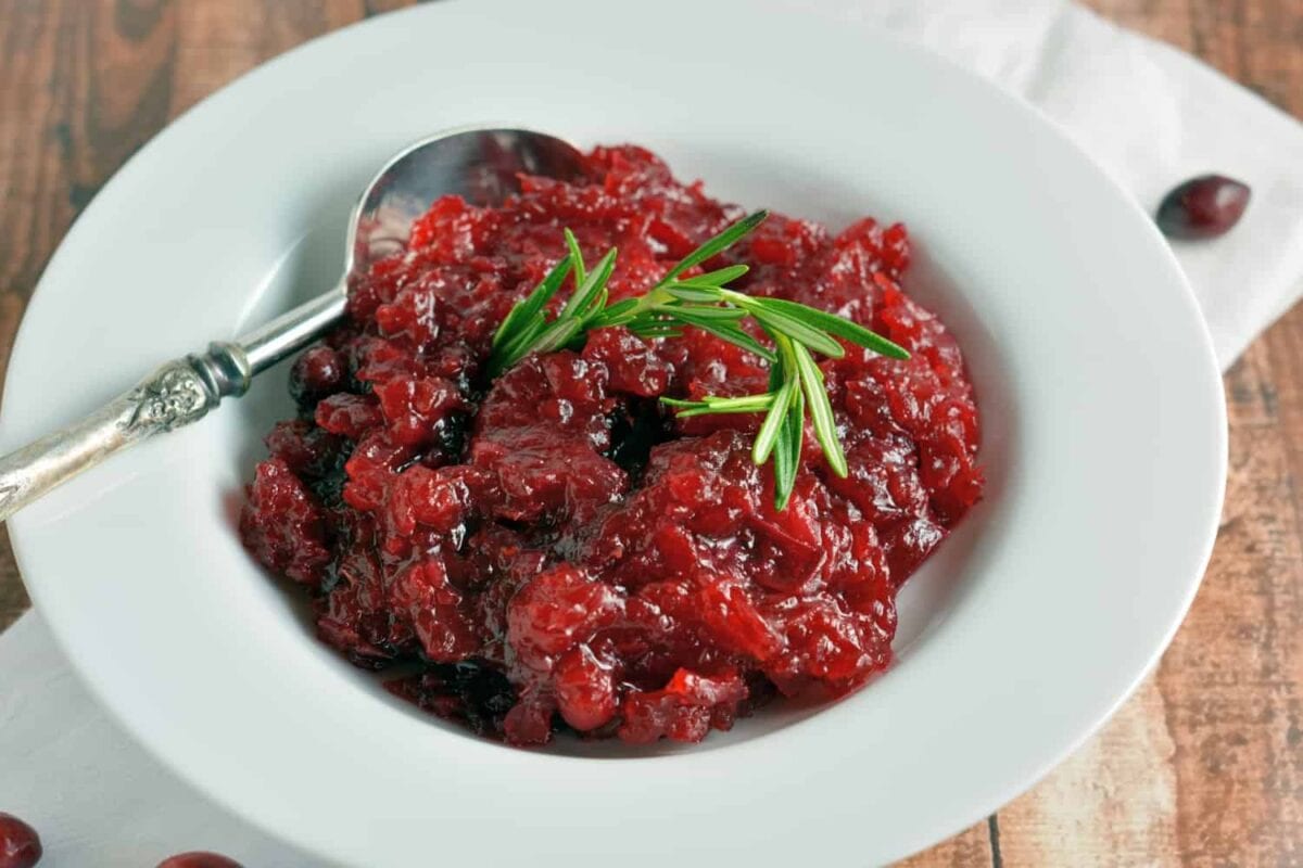 This homemade Cranberry Relish recipe is perfect for your Turkey Day festivities and will soon be a must-have every holiday season.  #cranberryrelish #cranberrysauce www.savoryexperiments.com