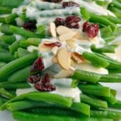 Green Beans in Mascarpone Cream Sauce is a sophisticated and delicious update to the old green bean casserole. It is sure to become a family favorite. #greenbeans #mascarponecreamsauce www.savoryexperiments.com